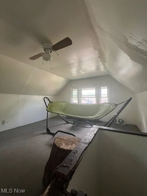 Bonus room with lofted ceiling, a ceiling fan, and carpet