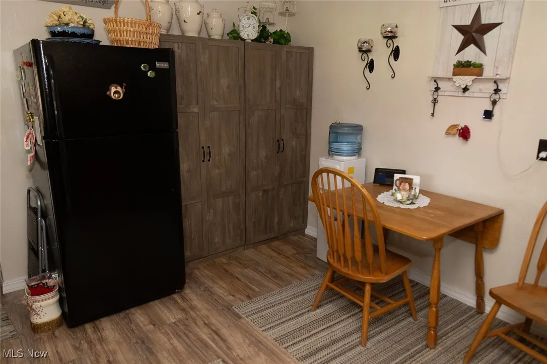 Dining space with wood finished floors and baseboards