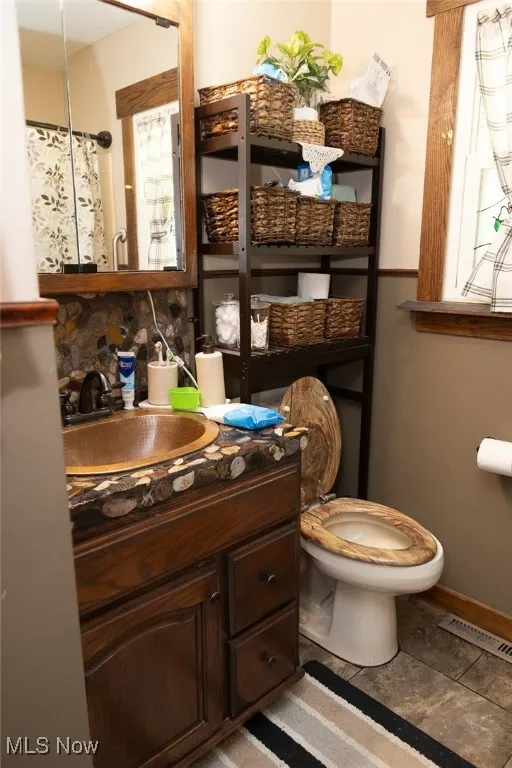 Full bath featuring toilet and vanity
