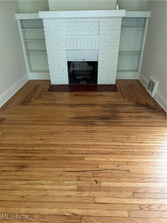 Detailed view of a fireplace and parquet flooring