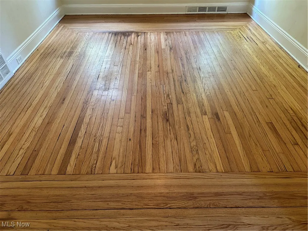 Detailed view of wood finished floors and baseboards