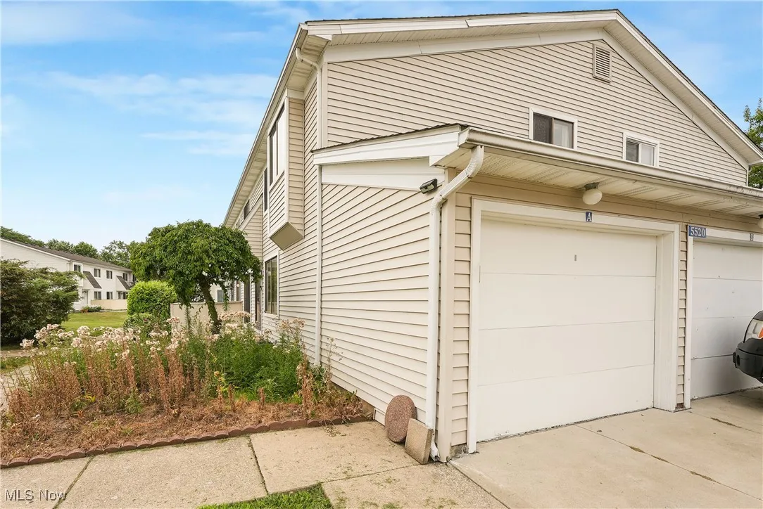 View of side of property with a garage