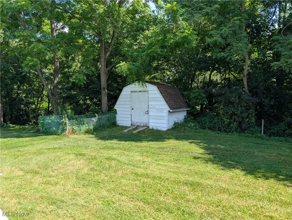 View of yard featuring a storage unit