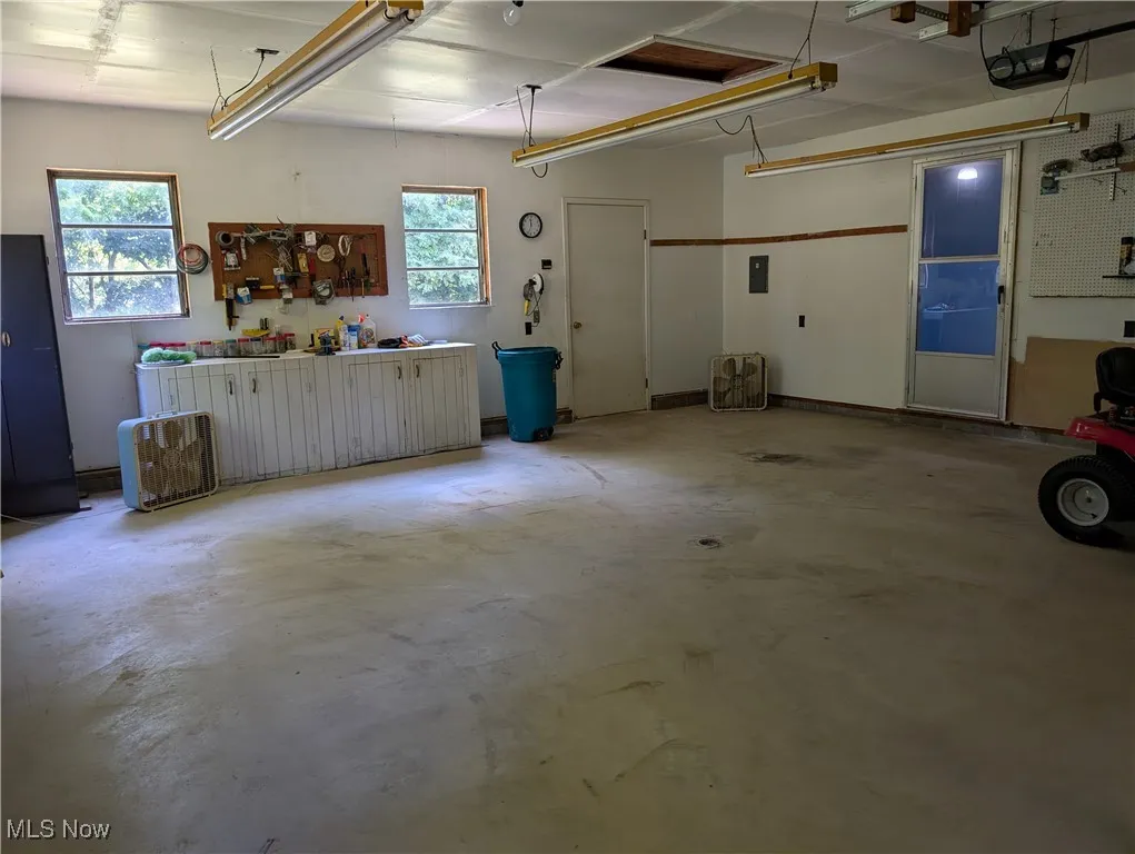 Garage with a workshop area and a garage door opener