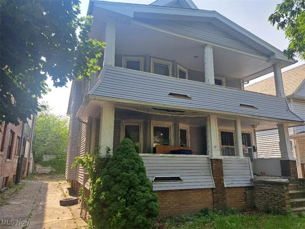 Rear view of property featuring covered porch