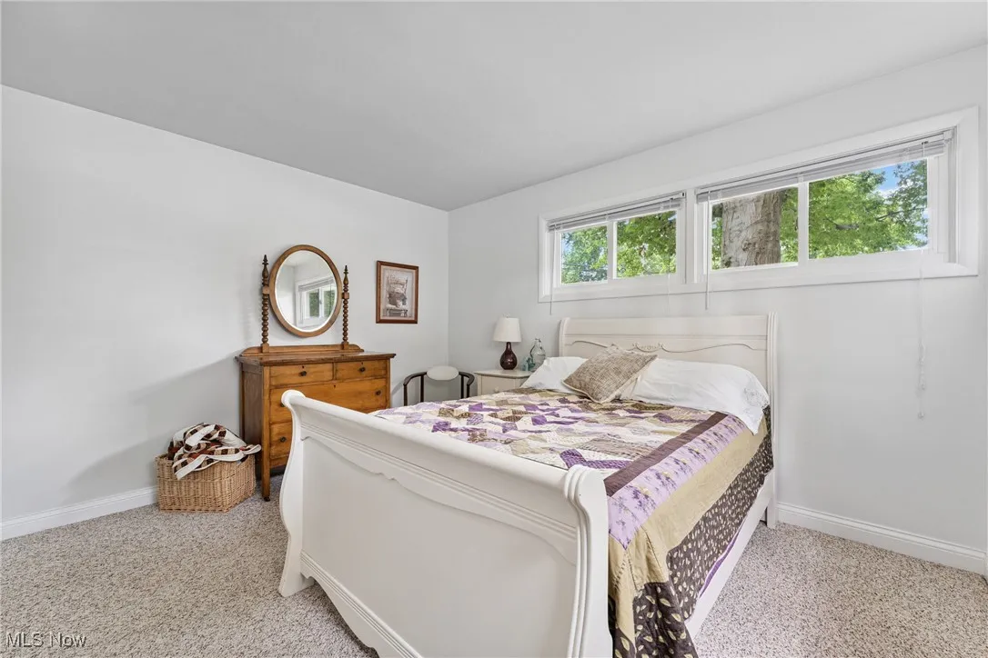 Bedroom featuring light carpet