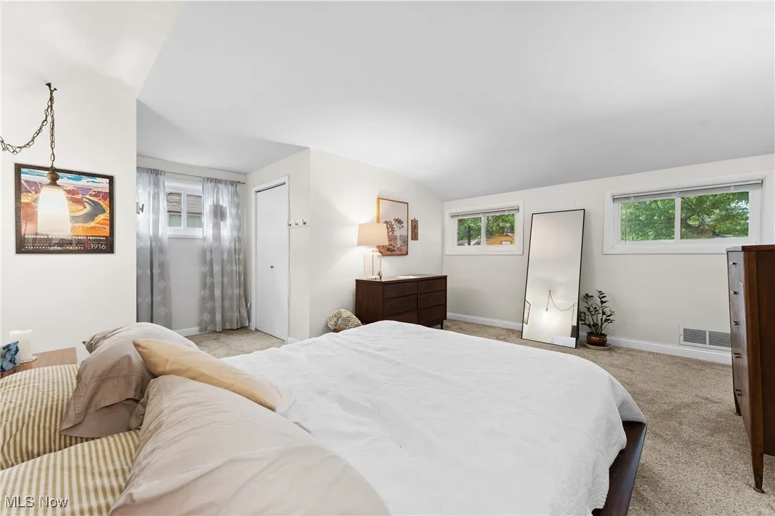 Bedroom featuring carpet floors and lofted ceiling