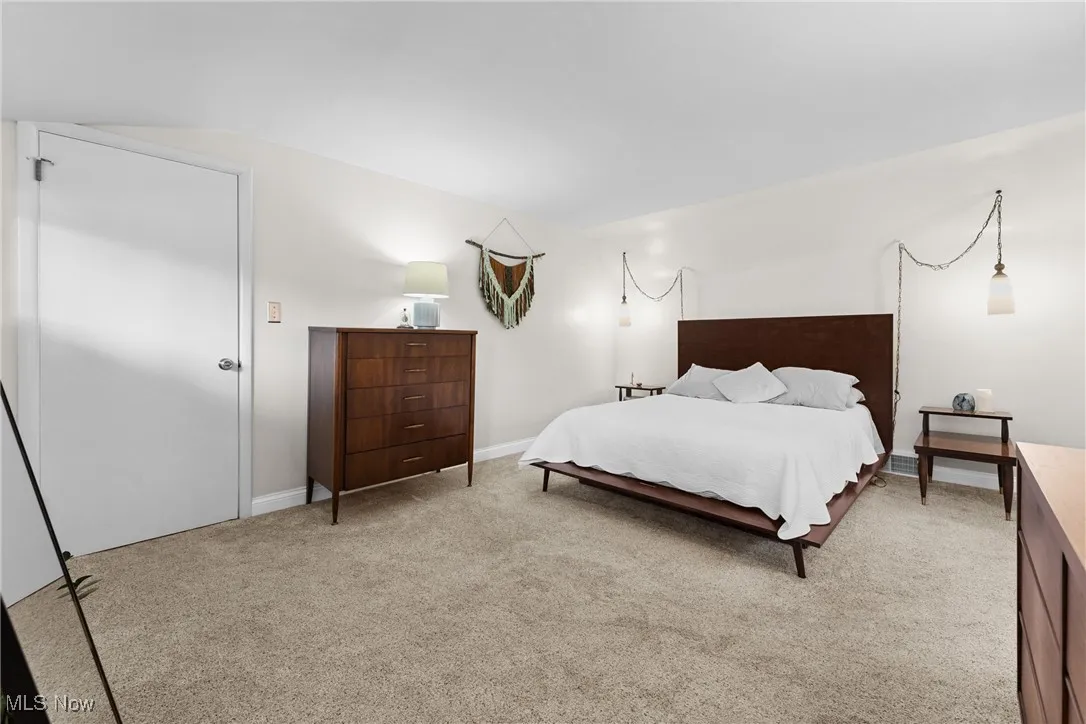 Carpeted bedroom with baseboards