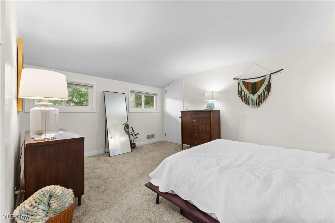 Bedroom with lofted ceiling and carpet flooring