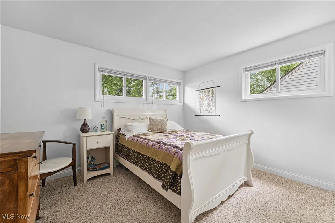 Bedroom featuring multiple windows and carpet