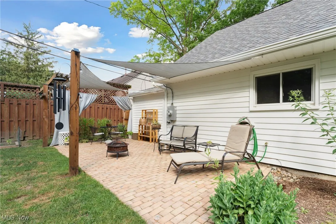 View of patio with an outdoor fire pit