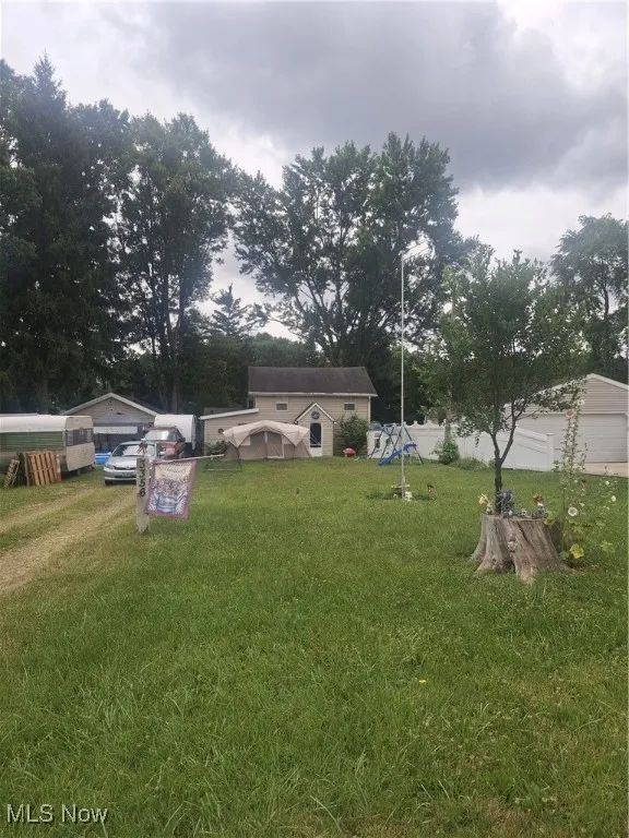 View of grassy yard with a playground