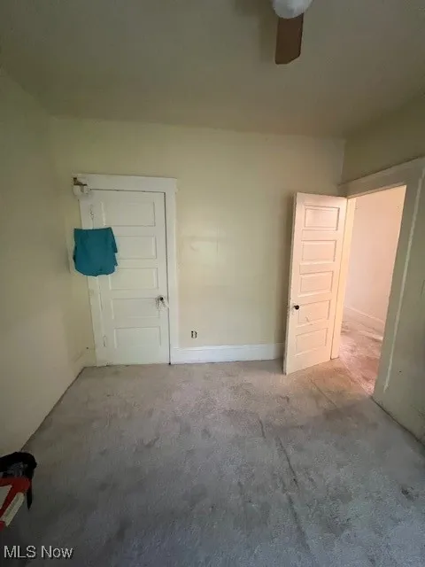 Unfurnished bedroom featuring carpet floors and ceiling fan