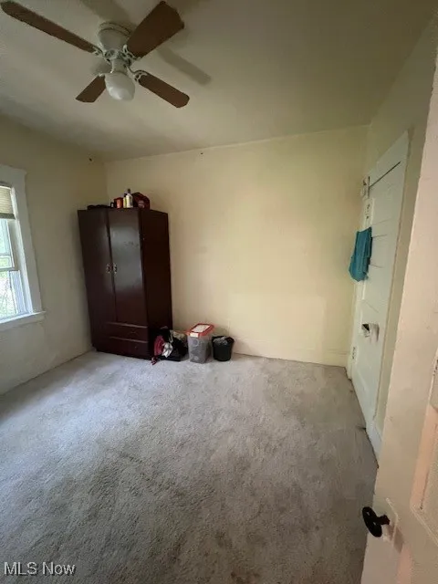 Unfurnished bedroom featuring carpet and a ceiling fan