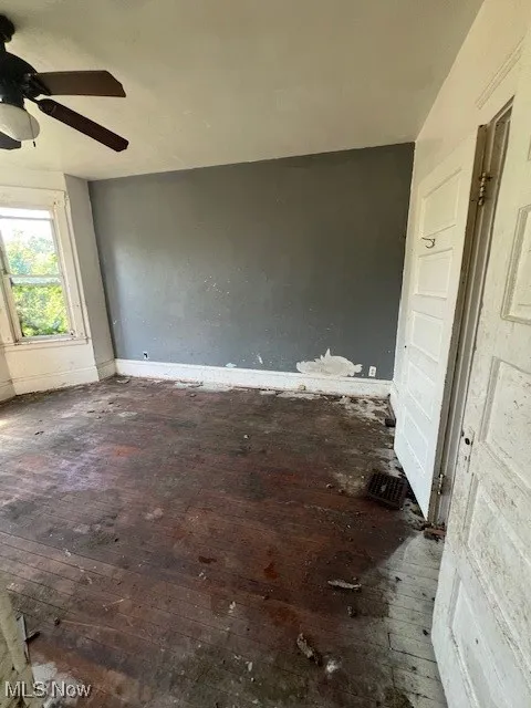 Spare room with wood-type flooring and ceiling fan