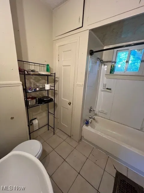 Bathroom featuring tile patterned flooring and shower / bath combination