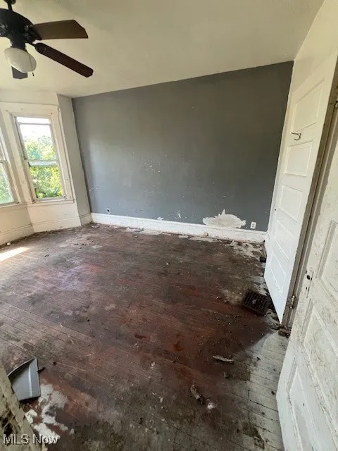 Spare room with hardwood / wood-style flooring and a ceiling fan