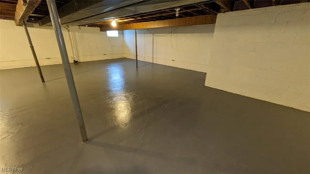 Unfinished below grade area with concrete block wall