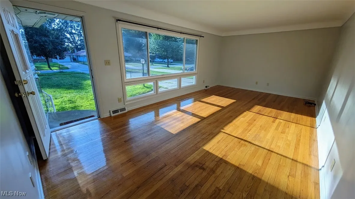 Spare room with wood finished floors and baseboards
