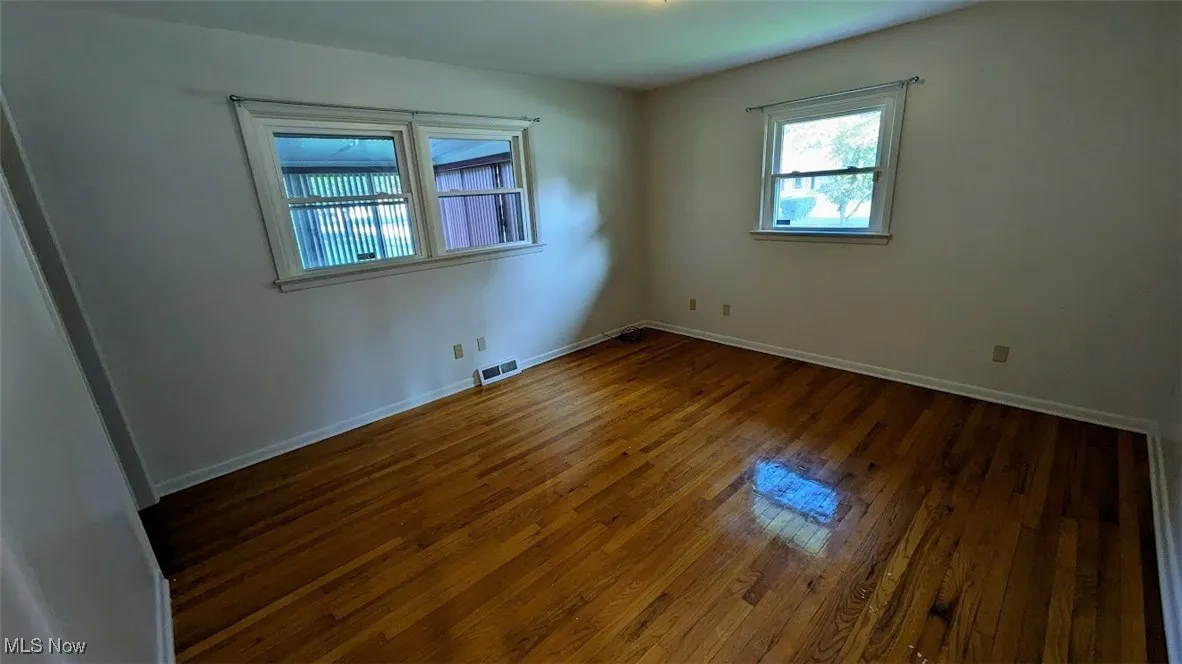 Empty room with wood finished floors and baseboards