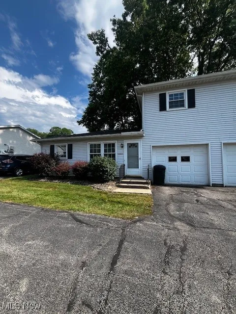View of front of property with an attached garage and driveway
