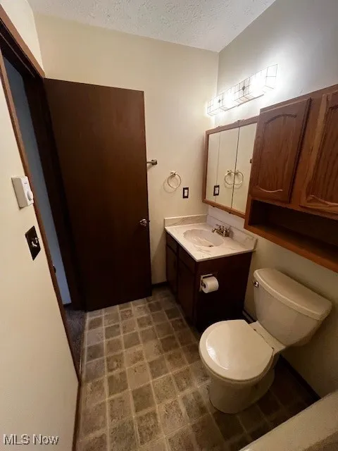 Bathroom featuring vanity and a textured ceiling