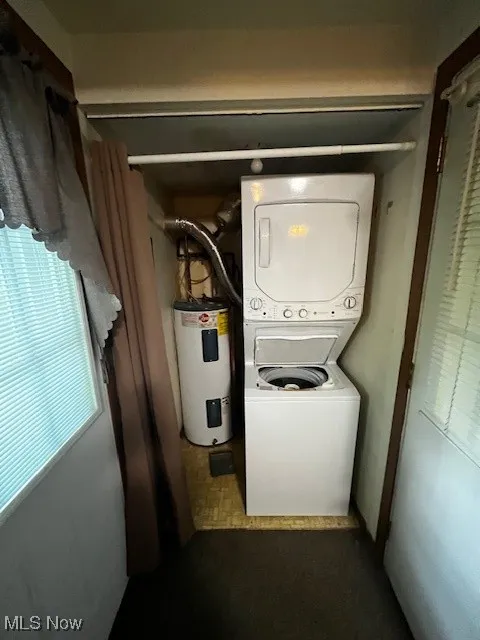 Washroom with stacked washer / dryer and water heater