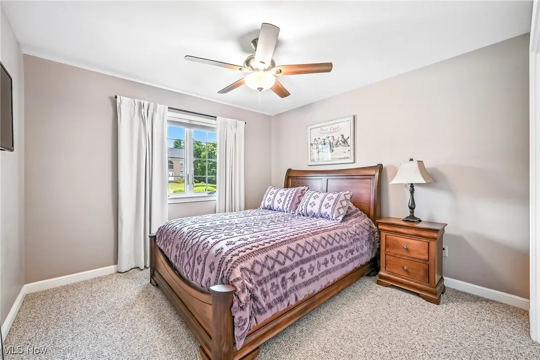 Bedroom featuring light carpet and ceiling fan