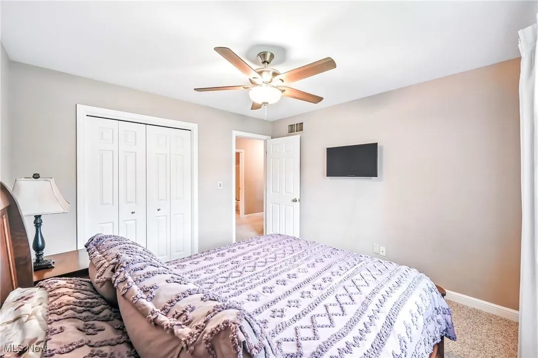 Bedroom featuring a closet, carpet flooring, and ceiling fan