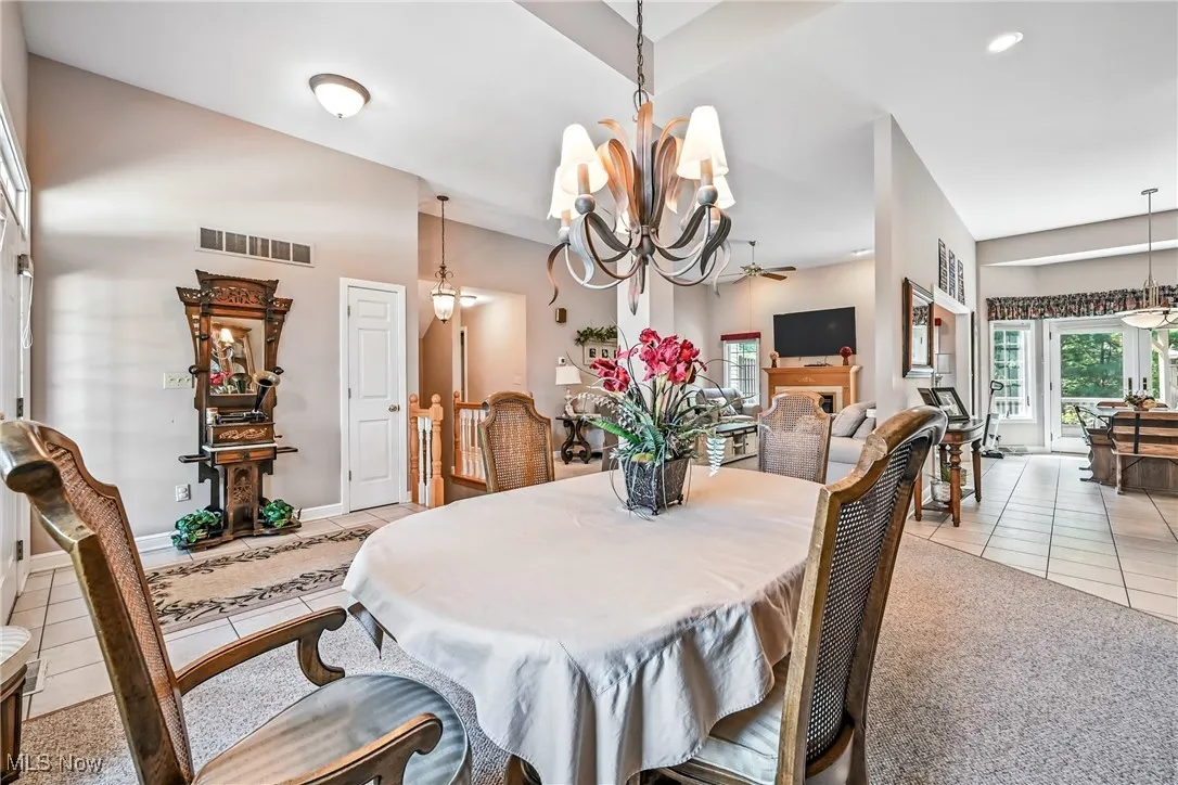 Dining room featuring light tile patterned flooring and a chandelier