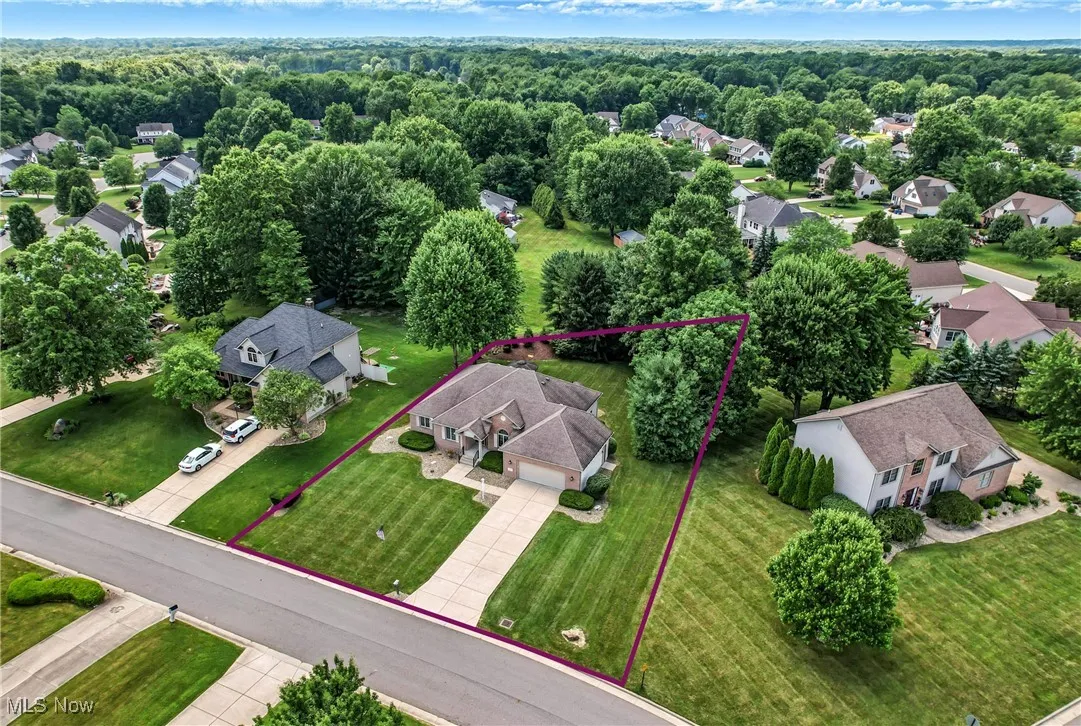 Aerial view of residential area featuring property boundaries highlighted