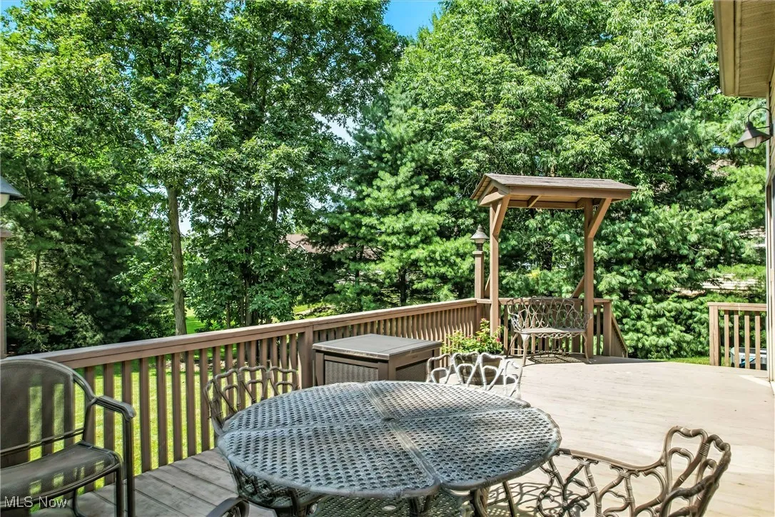 Wooden deck featuring outdoor dining area