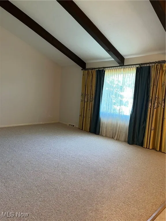 Carpeted empty room with baseboards