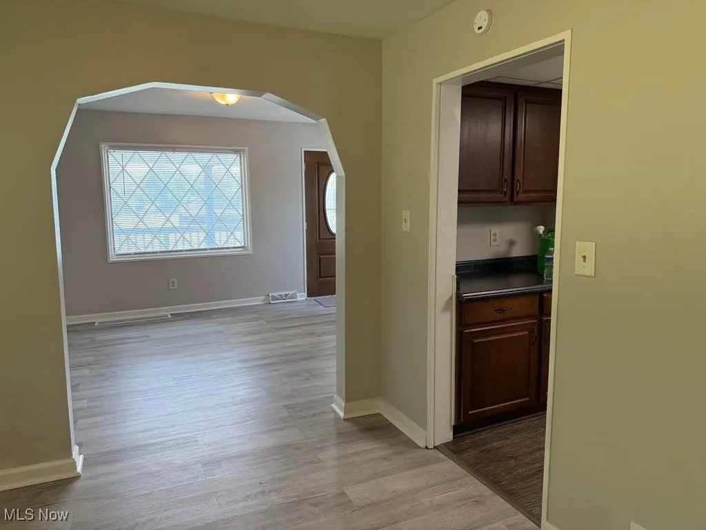Hallway featuring arched walkways