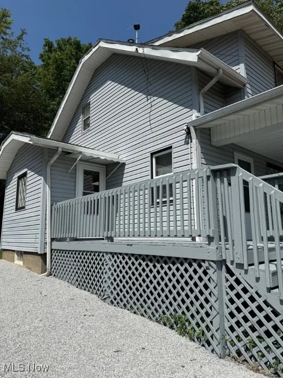 View of home's exterior with a wooden deck