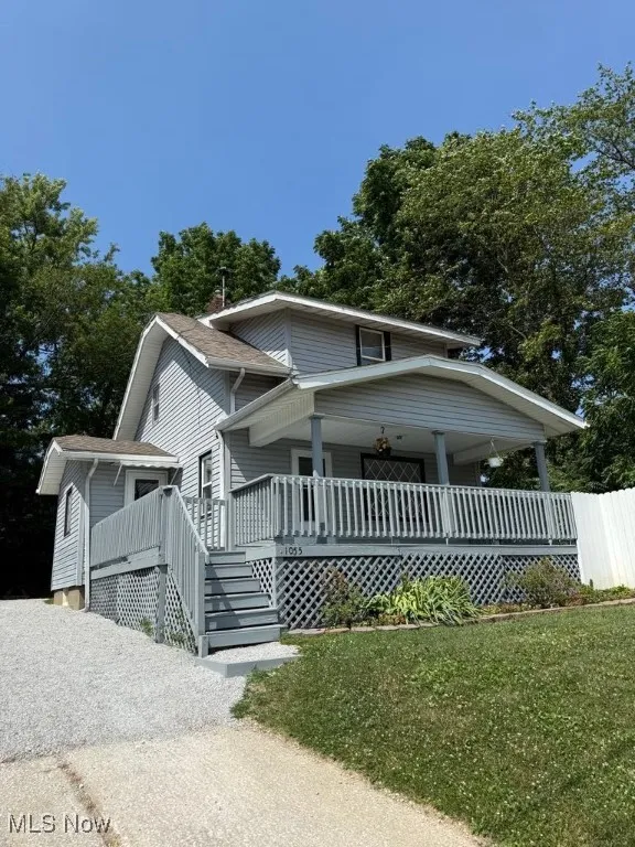 View of front of property featuring a porch and stairway