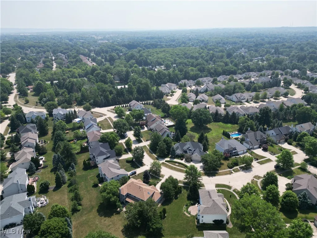 Aerial view of residential area featuring a heavily wooded area
