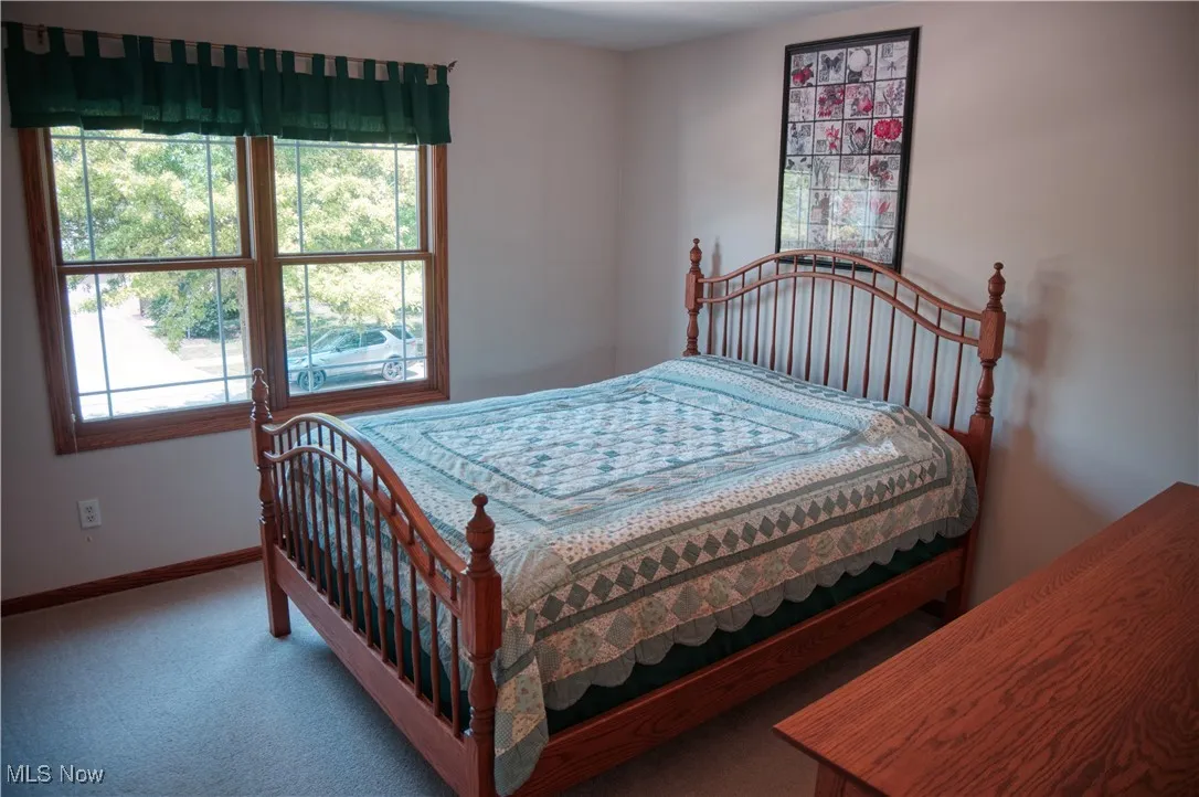 Carpeted bedroom featuring baseboards