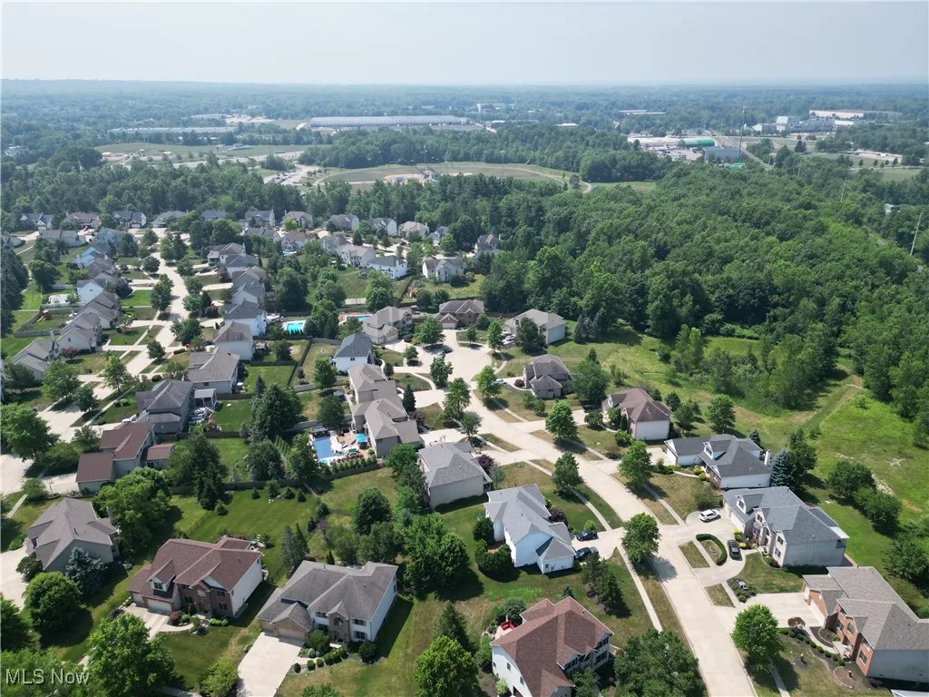 Aerial view of property's location with nearby suburban area