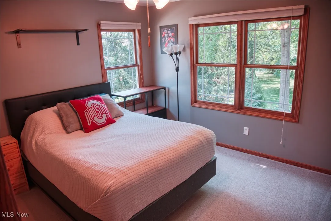 Bedroom with carpet flooring and baseboards