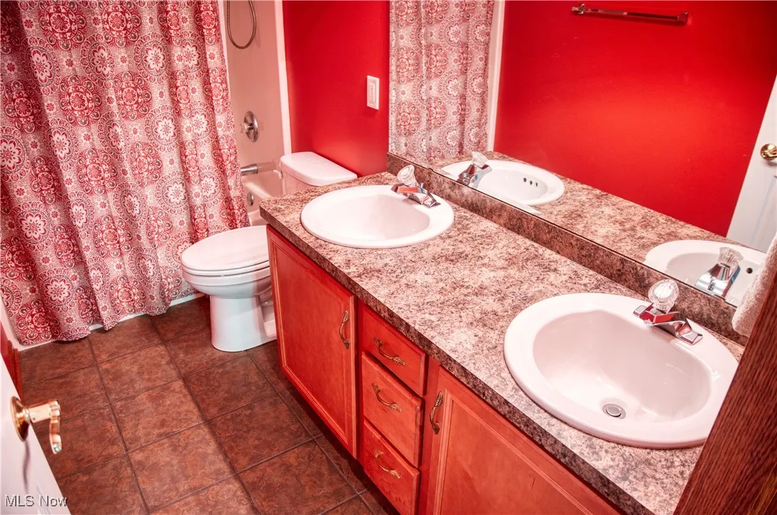 Bathroom featuring double vanity and tile patterned flooring