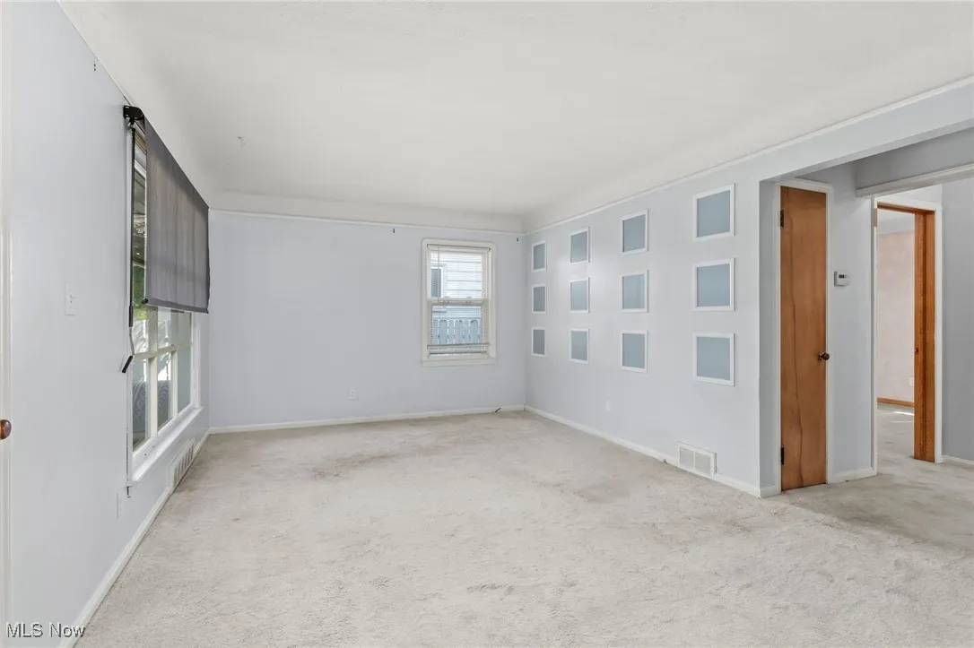 Carpeted spare room with baseboards