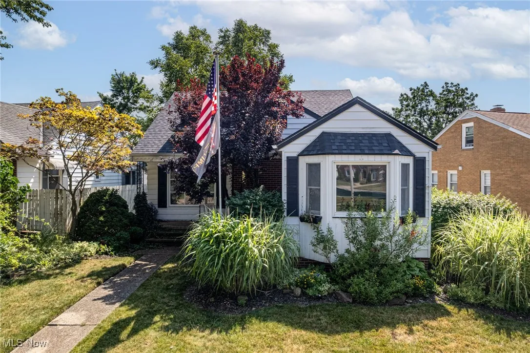 Bungalow-style home with roof with shingles