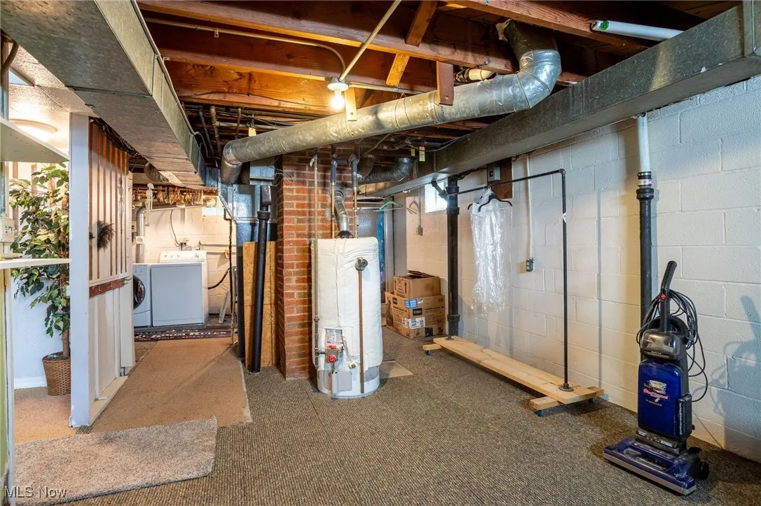 Basement with washing machine and dryer and water heater