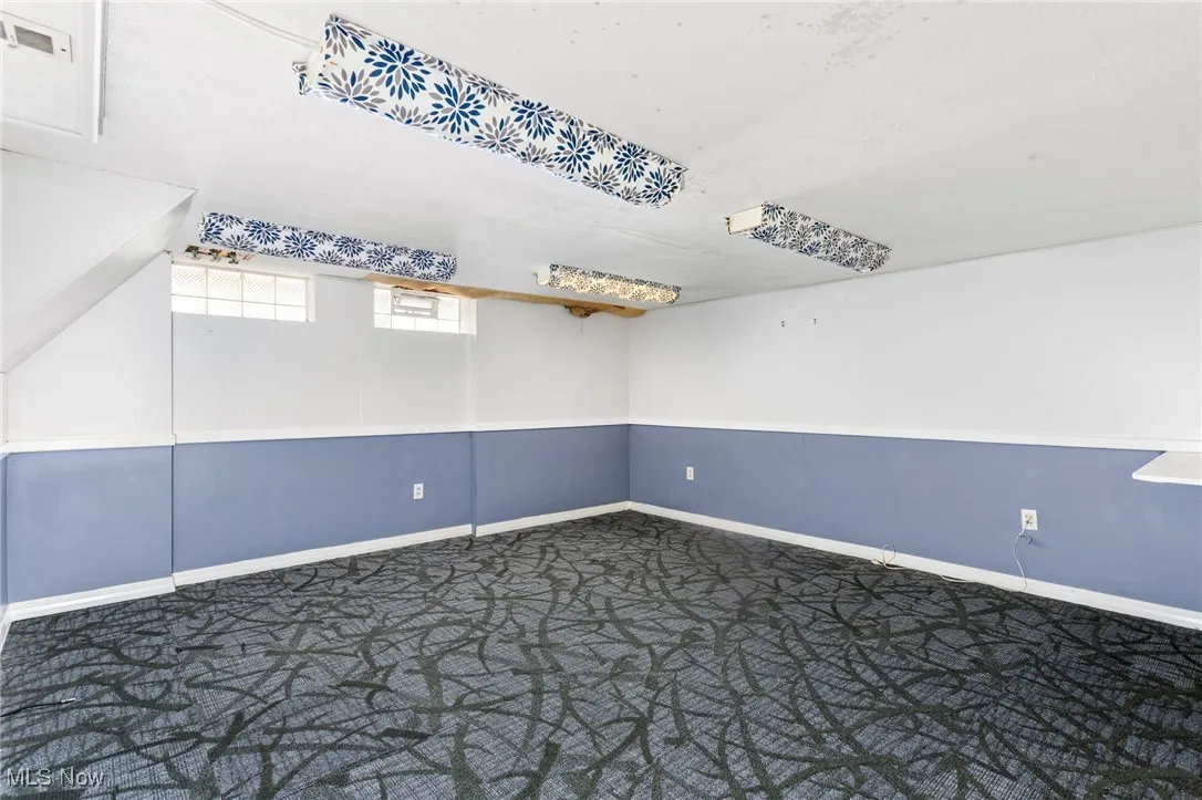 Carpeted spare room with baseboards