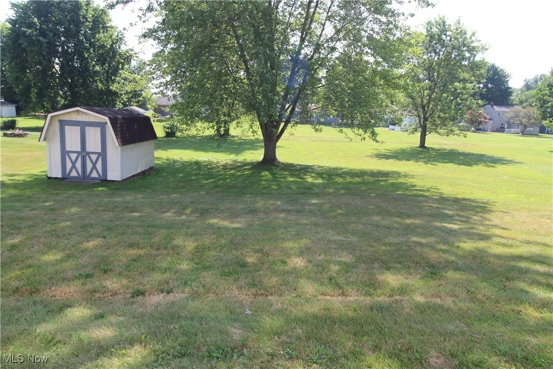 Deep yard with storage shed.