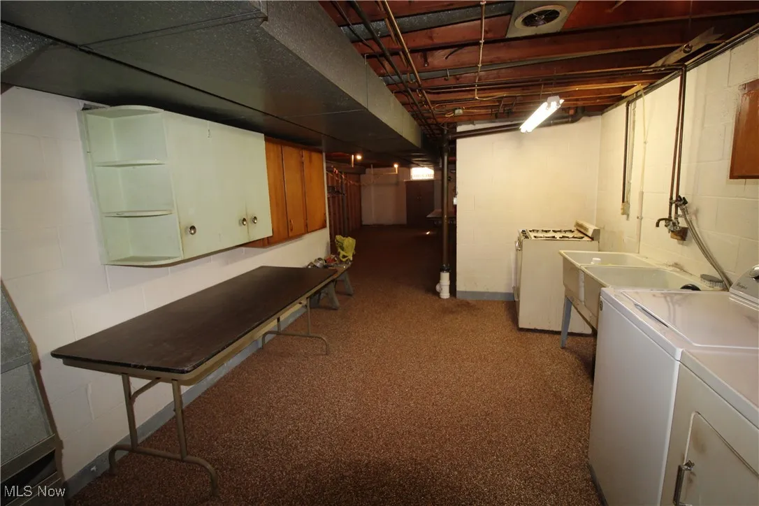 Laundry area with a tiled shower.