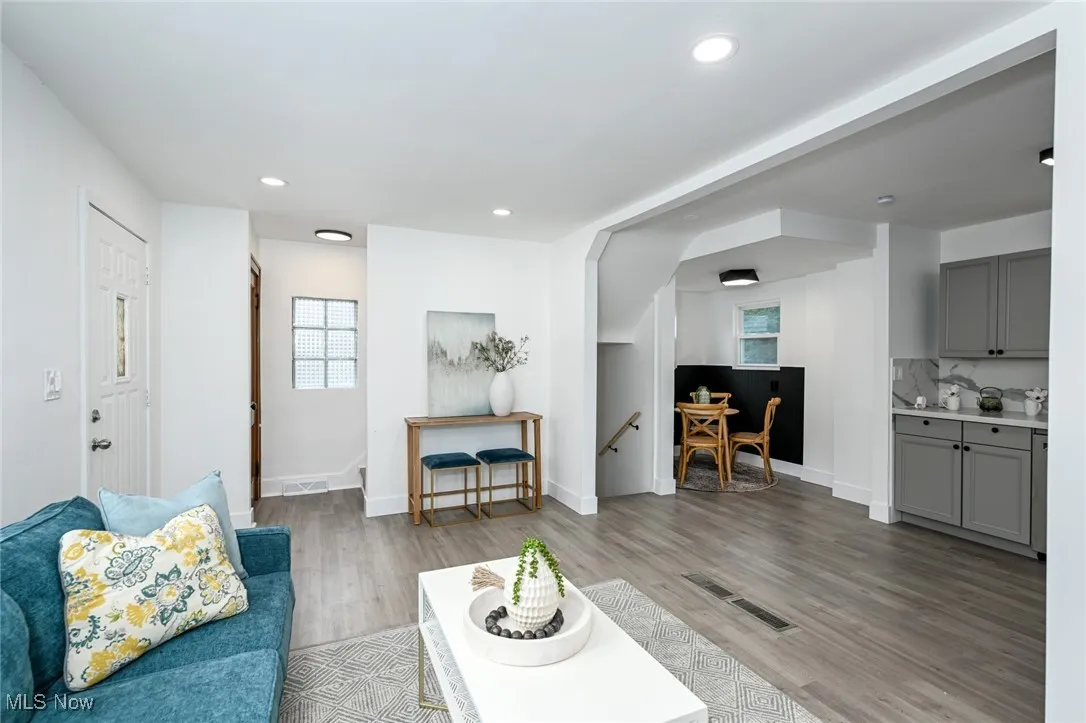 Living area featuring wood finished floors, plenty of natural light, and recessed lighting