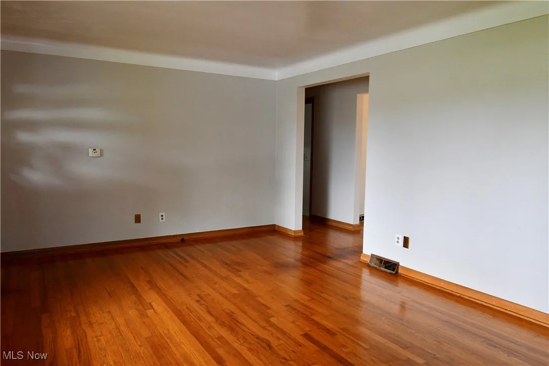 Spare room with wood finished floors and baseboards