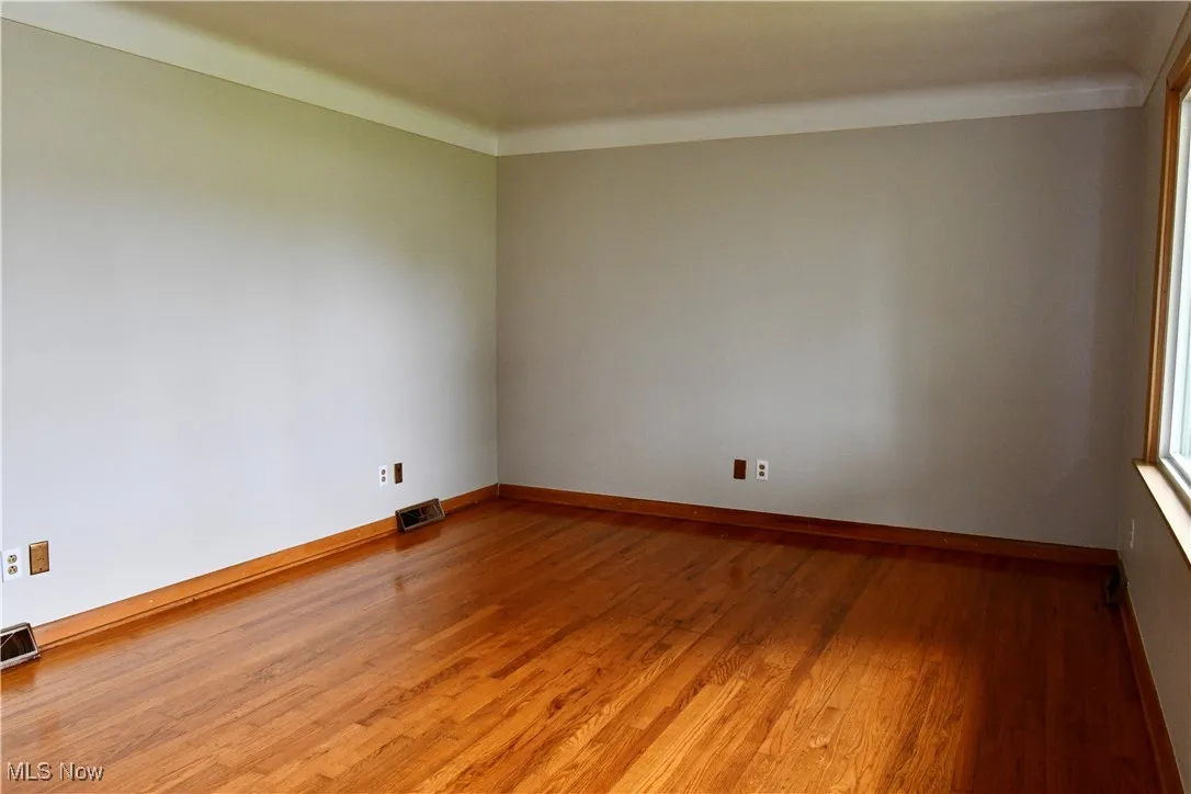 Spare room with light wood-type flooring and baseboards